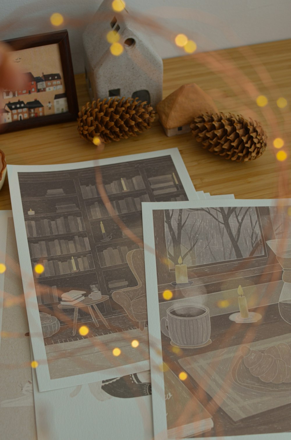 a table topped with pictures and pine cones