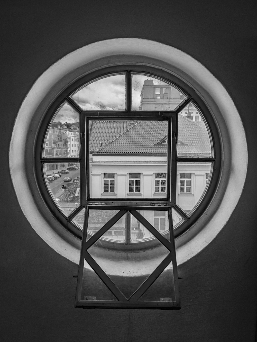 a circular window with a view of a building