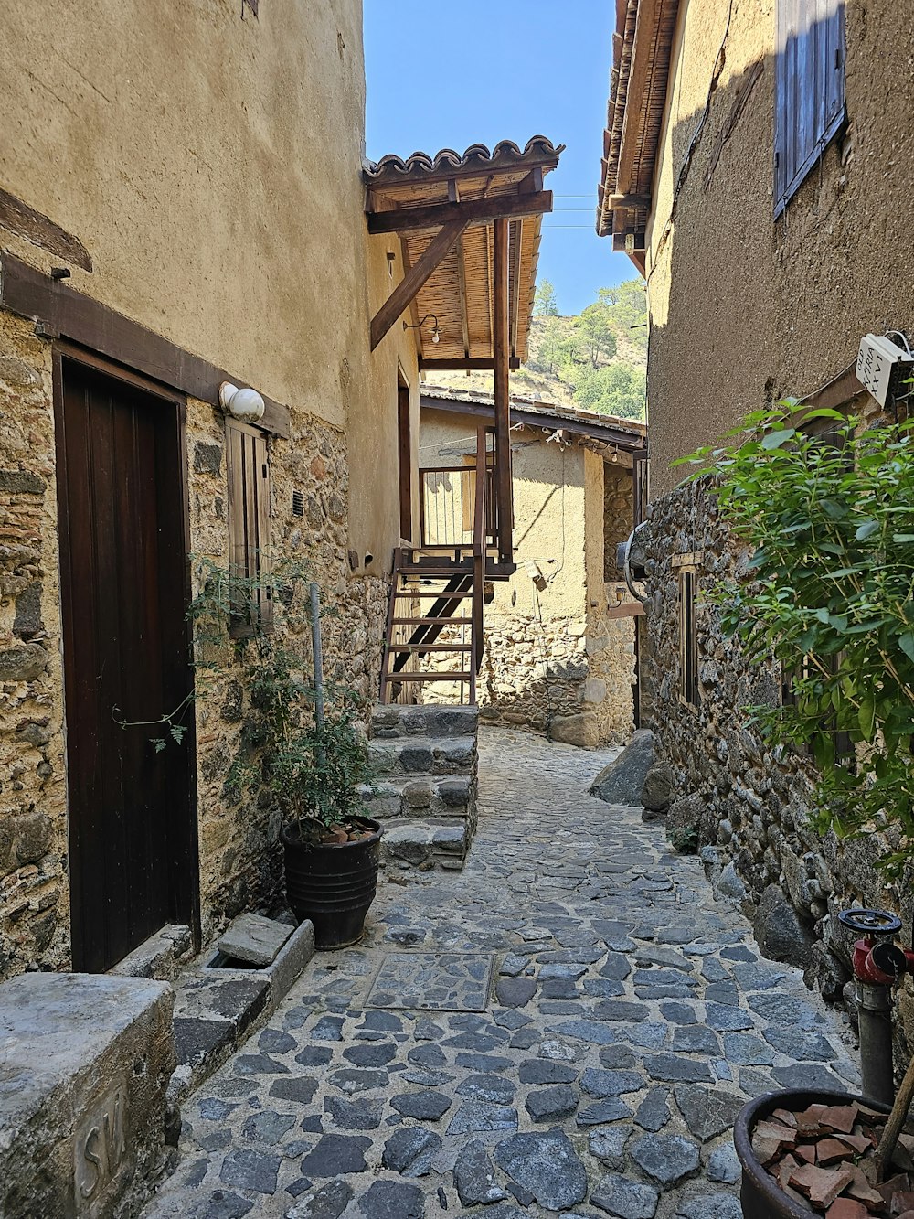 a cobblestone street with steps leading up to a building