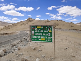 a sign on the side of a road that says you are now higher than ever