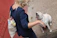 A happy customer holding a bag of pet supplies at Blue Daisy Pet Supply.