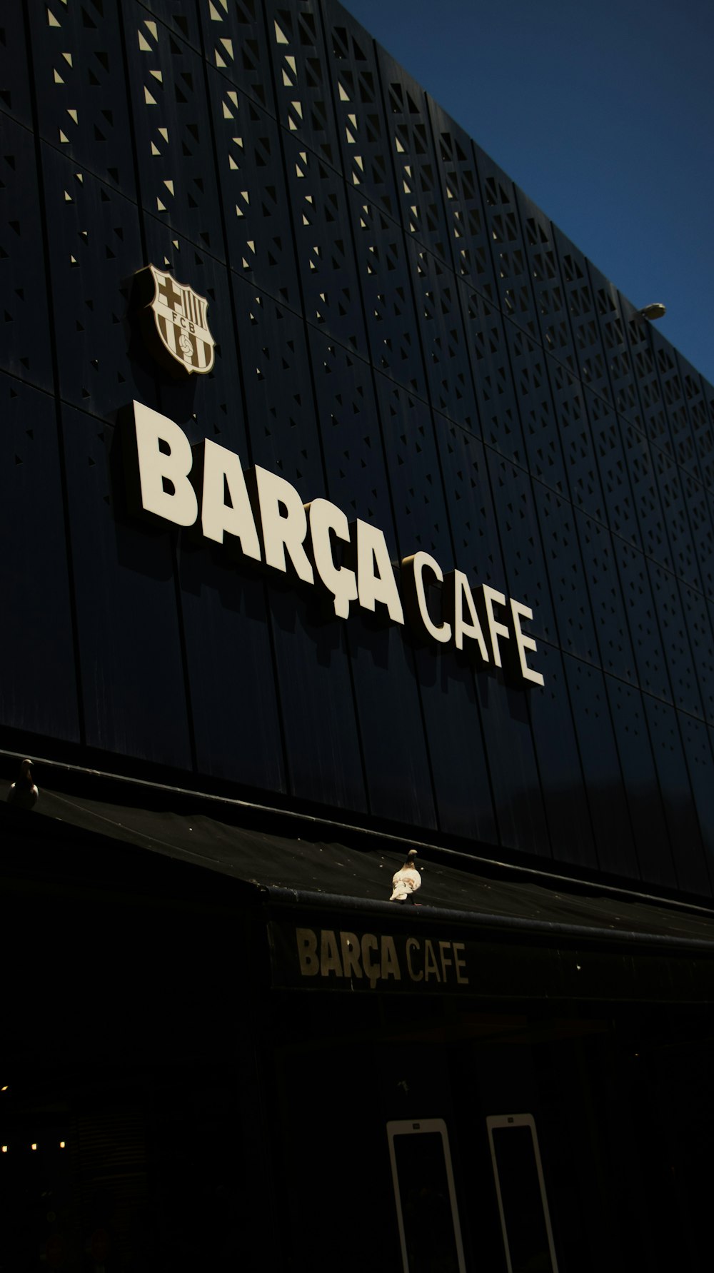 a barca cafe sign on the side of a building