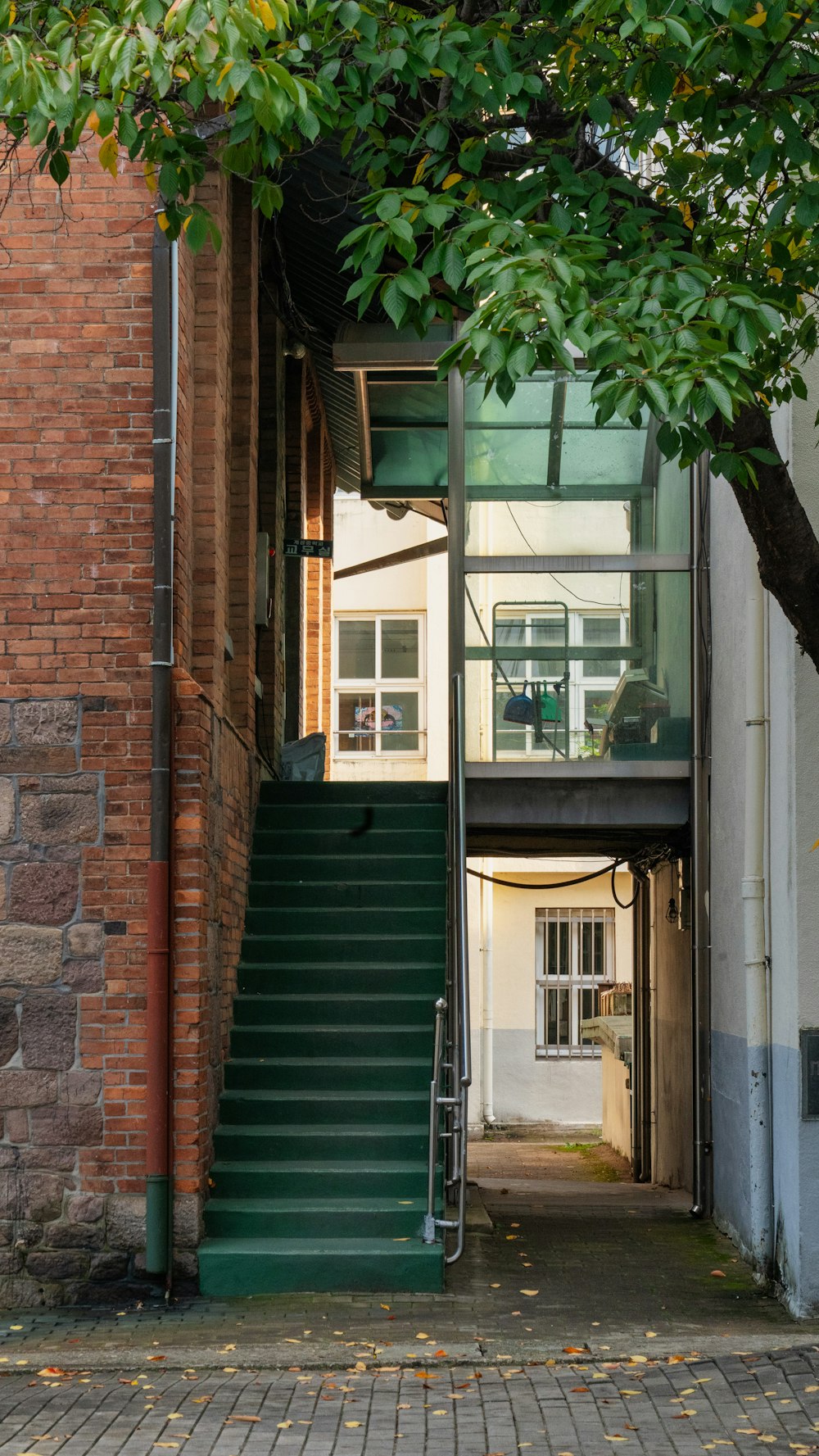 a green staircase going up to a building