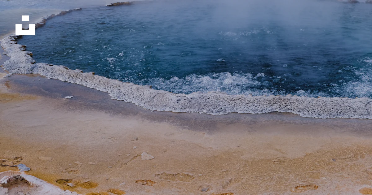 A large body of water with steam rising out of it photo – Free ...