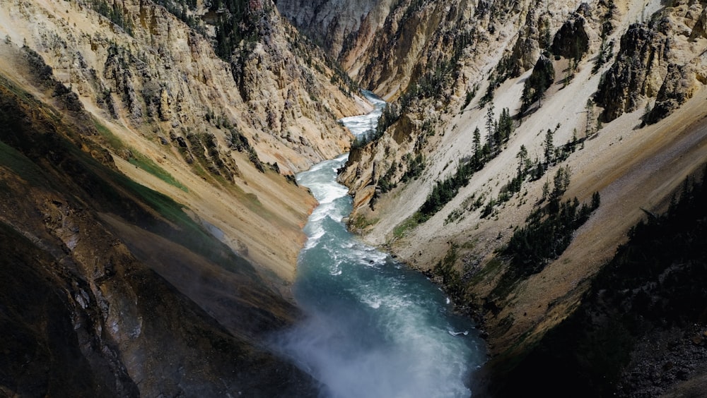 a river running through a canyon surrounded by mountains