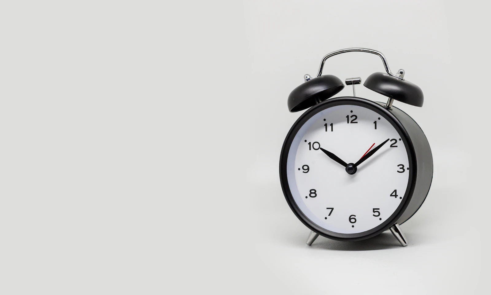 A picture of a black alarm on a white table.