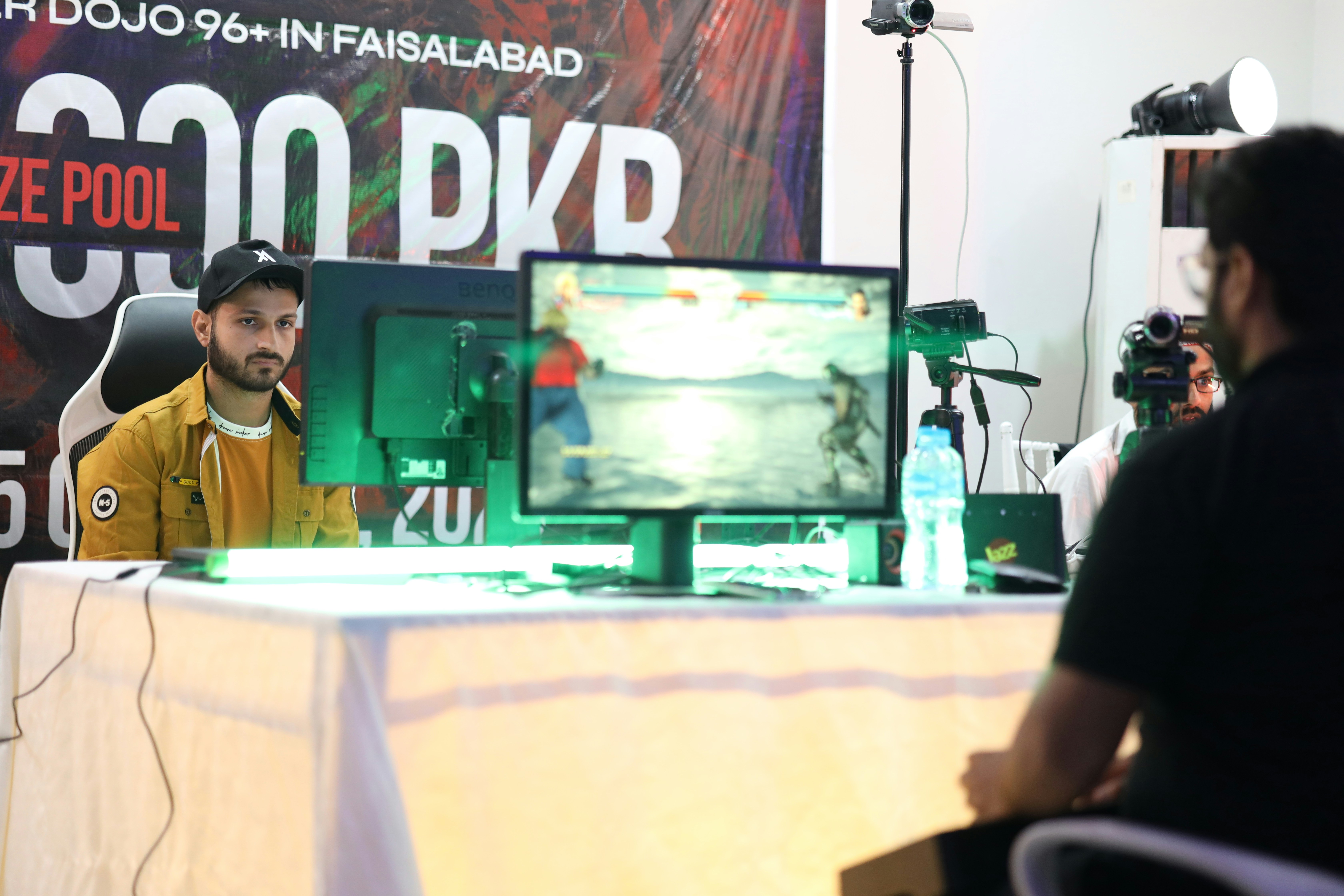 a man sitting in front of a tv on top of a table