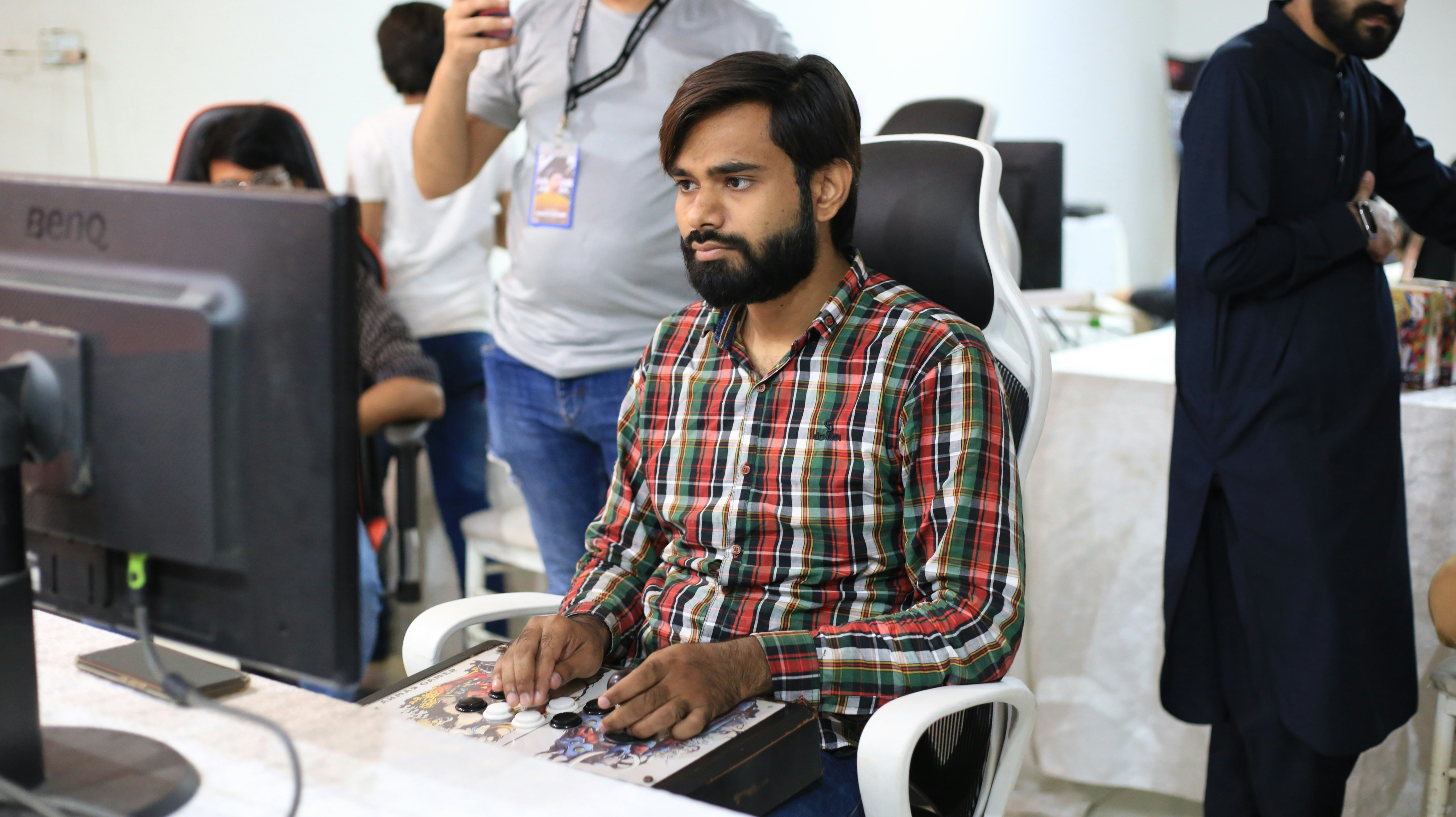 a man sitting in front of a computer monitor
