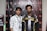 Two individuals stand in front of a backdrop with logos and text, dressed in casual clothing and sporting lanyards with badges. The individual on the left wears a patterned shirt, while the one on the right wears a shirt with the words 'Pathan Esports'.