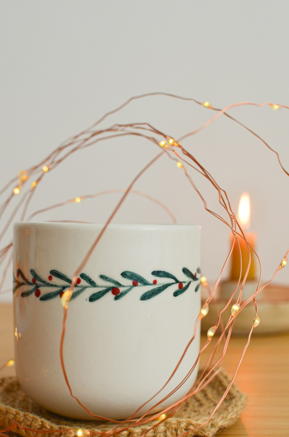 a coffee cup with a string of lights around it
