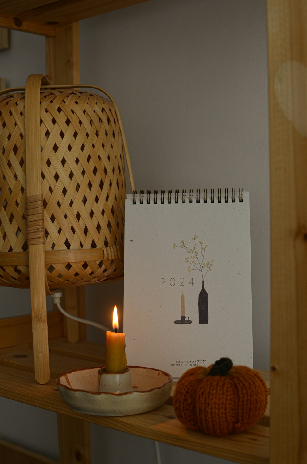 a table with a candle and a calendar on it
