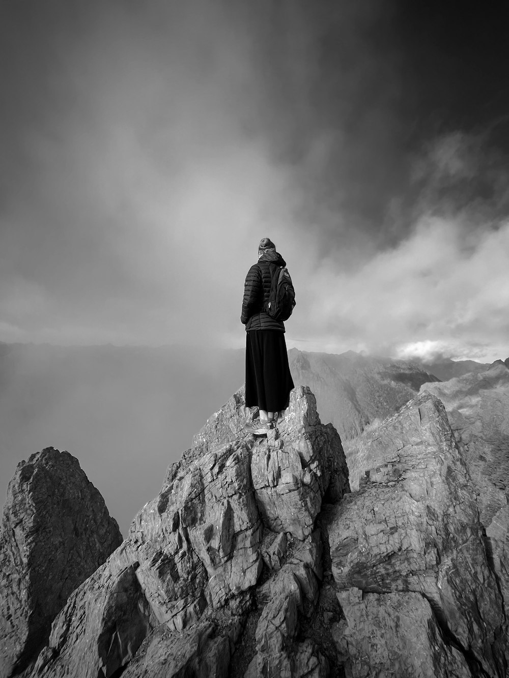 a person standing on top of a rocky mountain