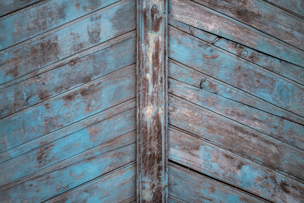 a close up of a wooden wall with peeling paint