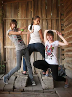 Friends striking playful poses in front of the 360 video booth with warm golden lighting.