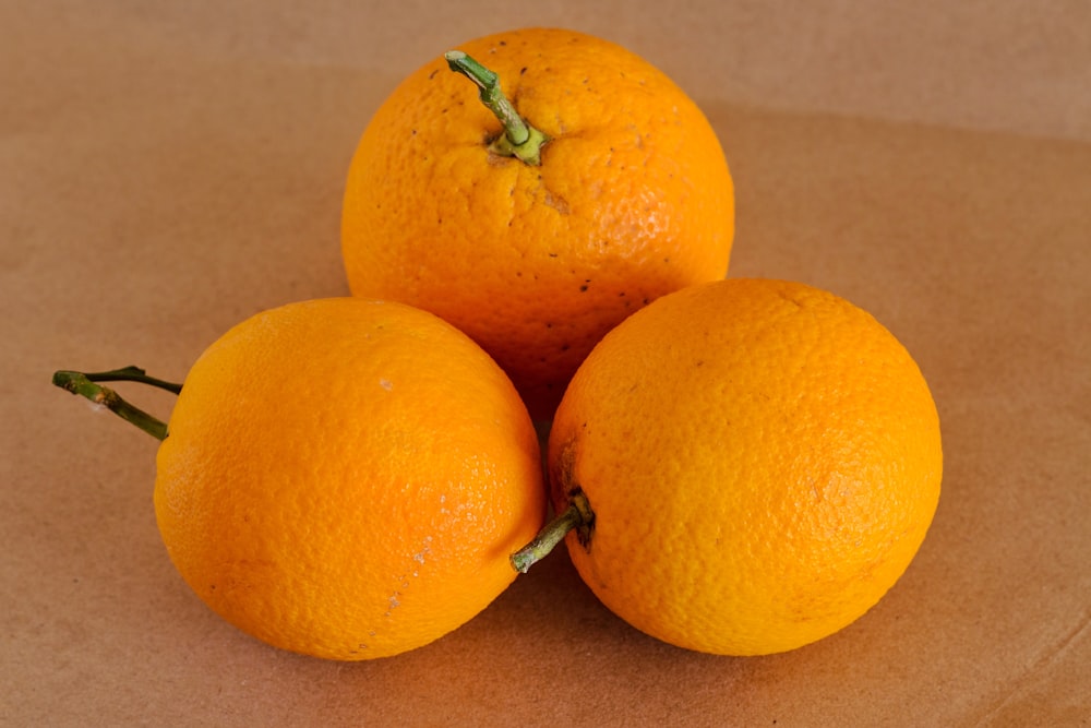 three oranges sitting on top of each other