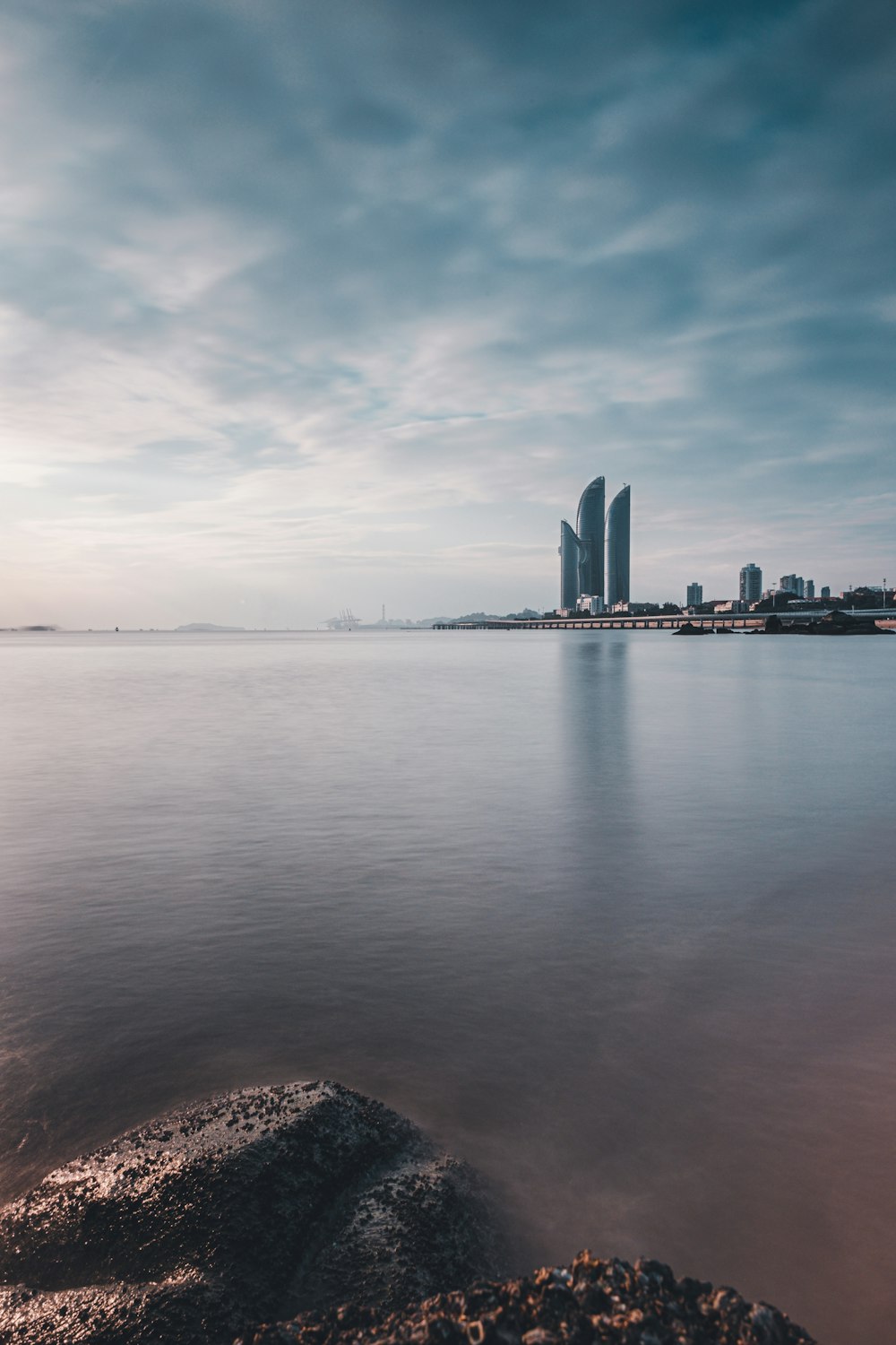 a large body of water with a city in the background