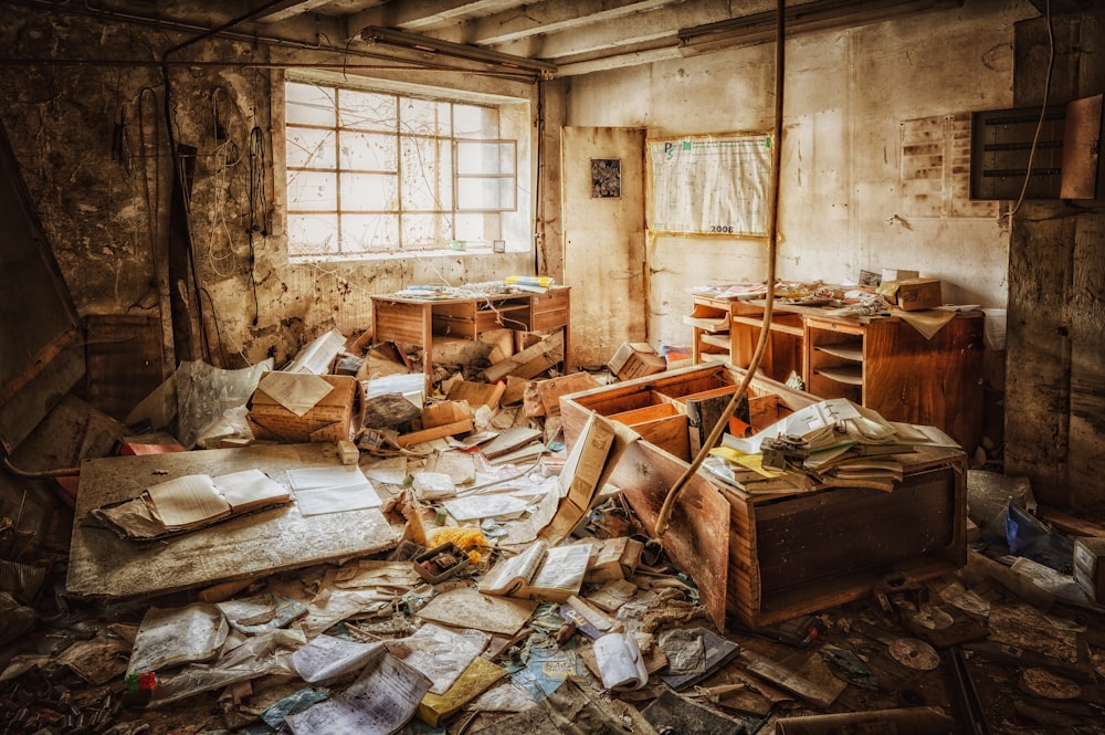 a room filled with lots of junk next to a window