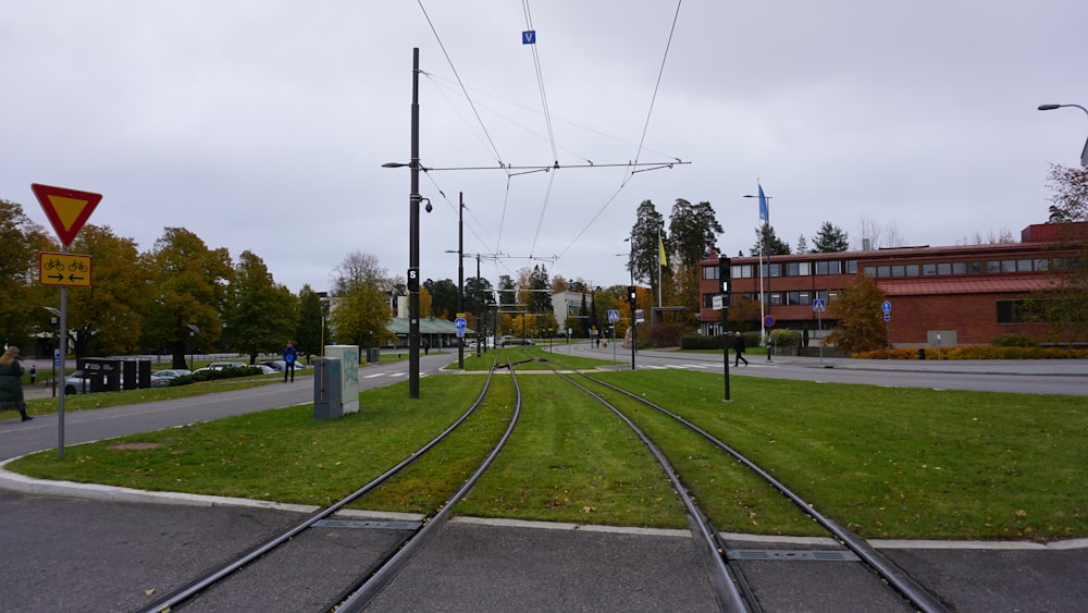 a view of a train track with a building in the background