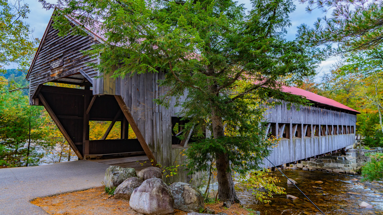 A wooden covered bridge over a river