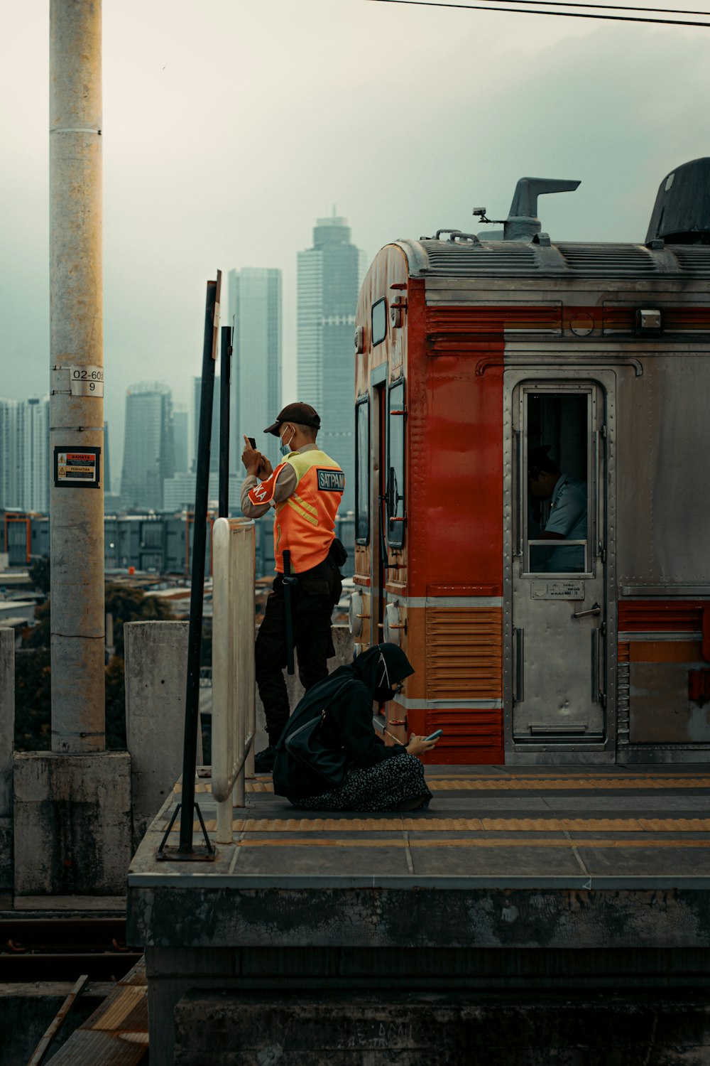 a man standing on a platform next to a train