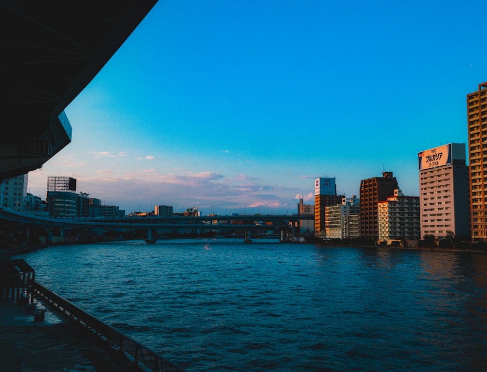 a view of a river with a bridge in the background