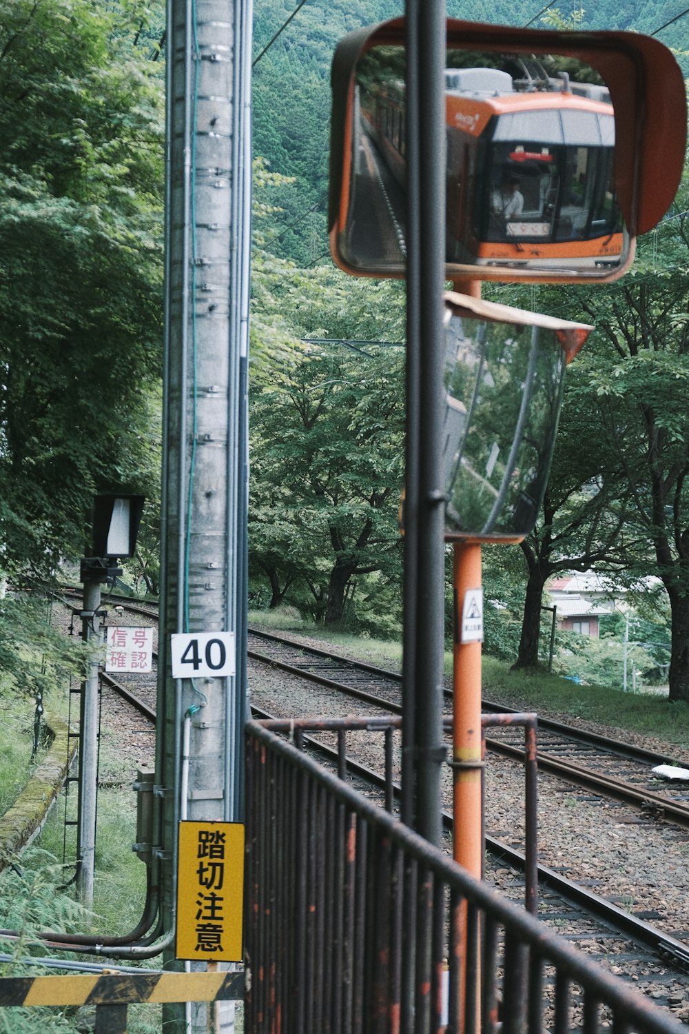 a train traveling down train tracks next to a forest