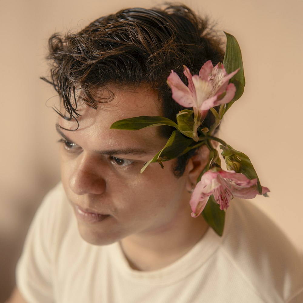 a man with a flower in his hair