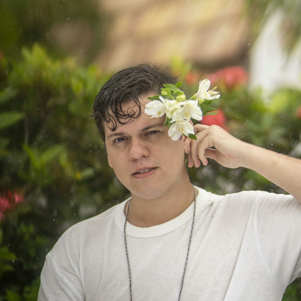 a man with a flower in his hair