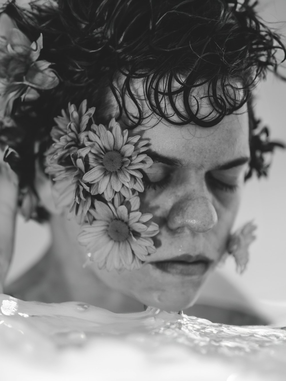 a woman with flowers in her hair in the water