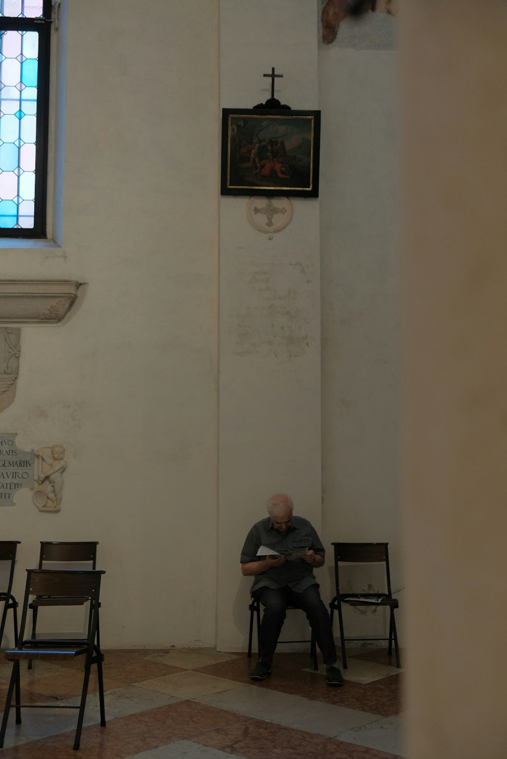 a man sitting in a chair in a church