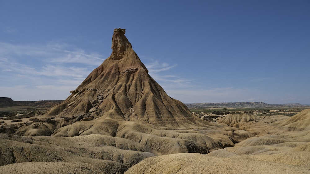 a large rock formation in the middle of a desert