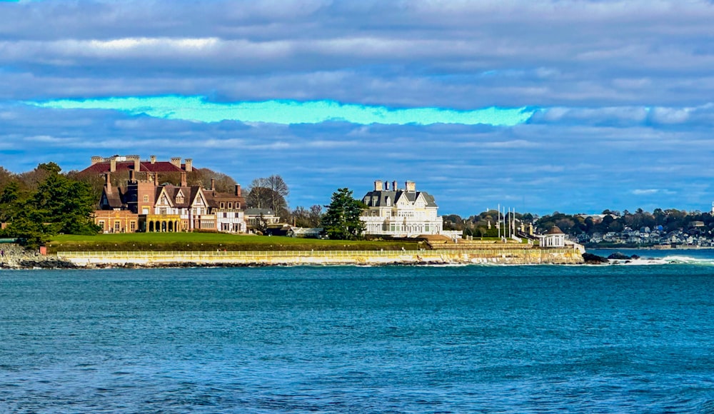 a large body of water with houses in the background