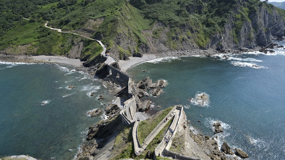 an aerial view of a castle on a cliff overlooking the ocean