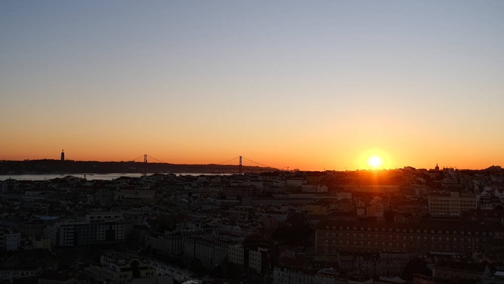 the sun is setting over a large city