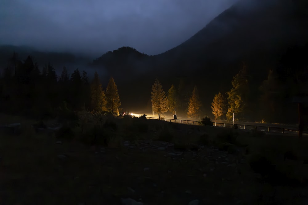 a foggy night in the mountains with people walking