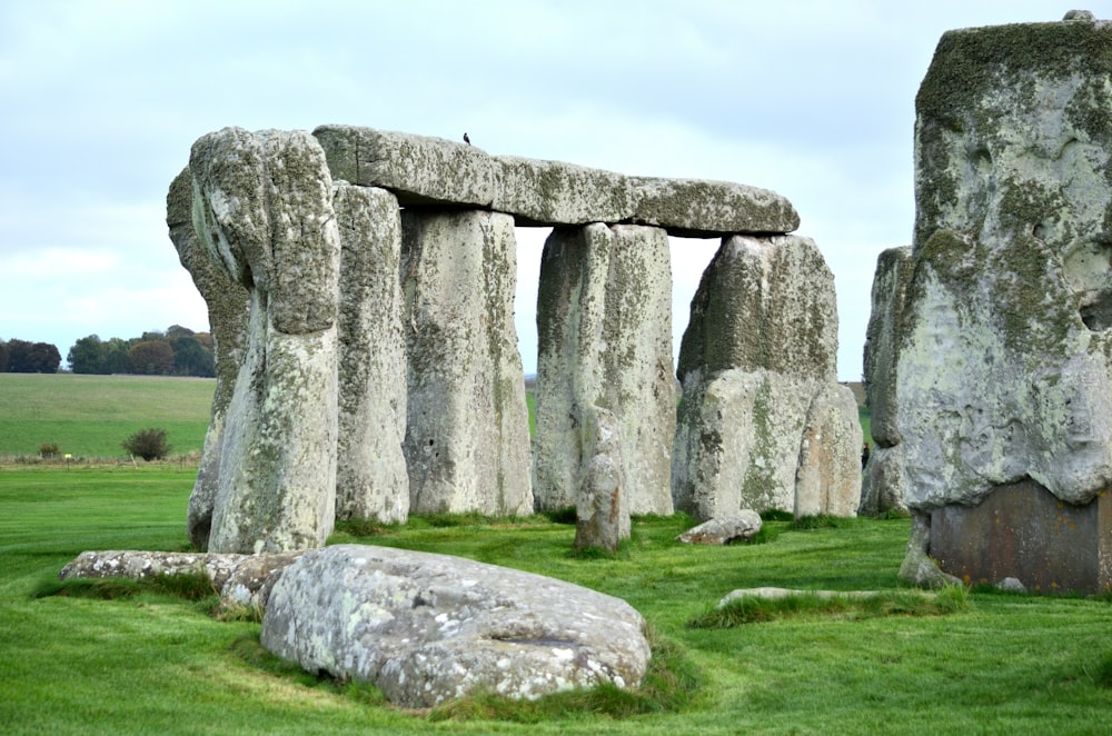 a large stone structure in a grassy field