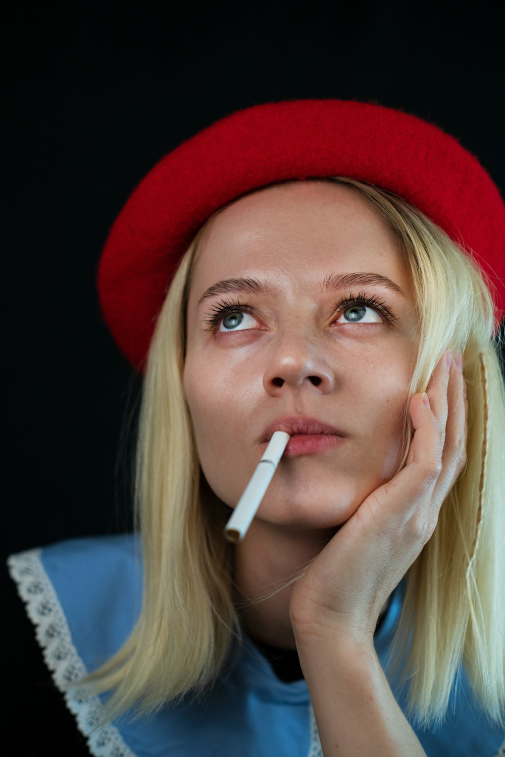 a woman with a cigarette in her mouth