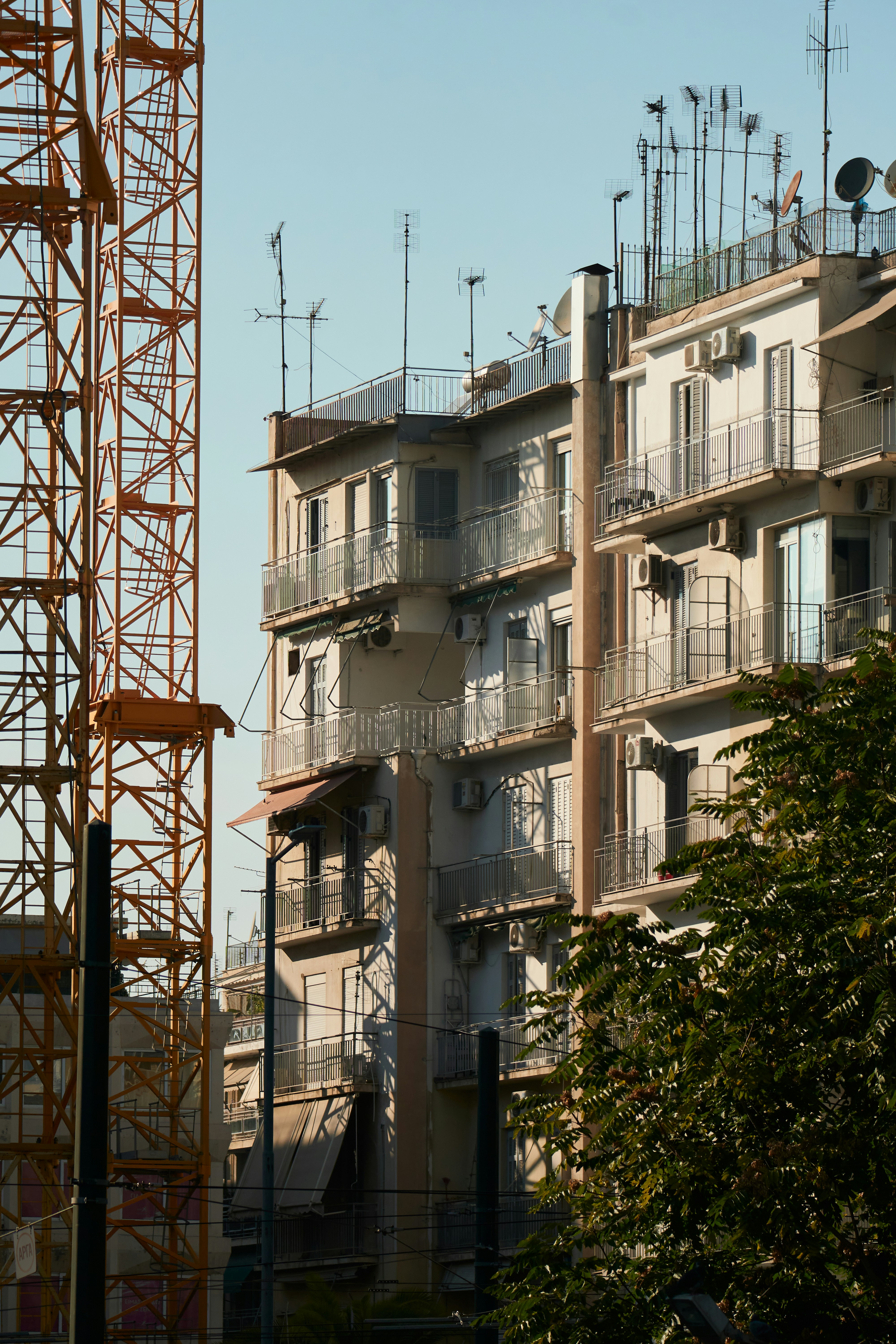 a tall building with lots of balconies on top of it