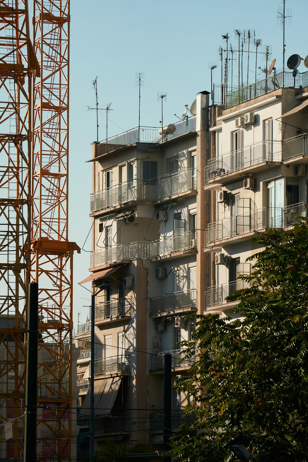 a tall building with lots of balconies on top of it