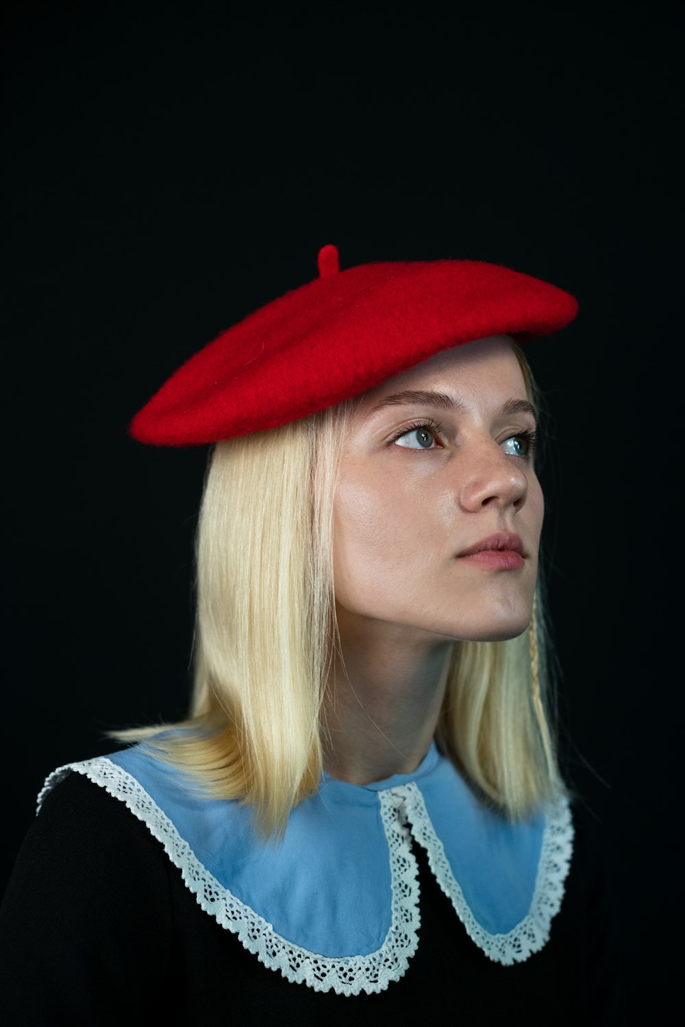 a woman with blonde hair wearing a red hat