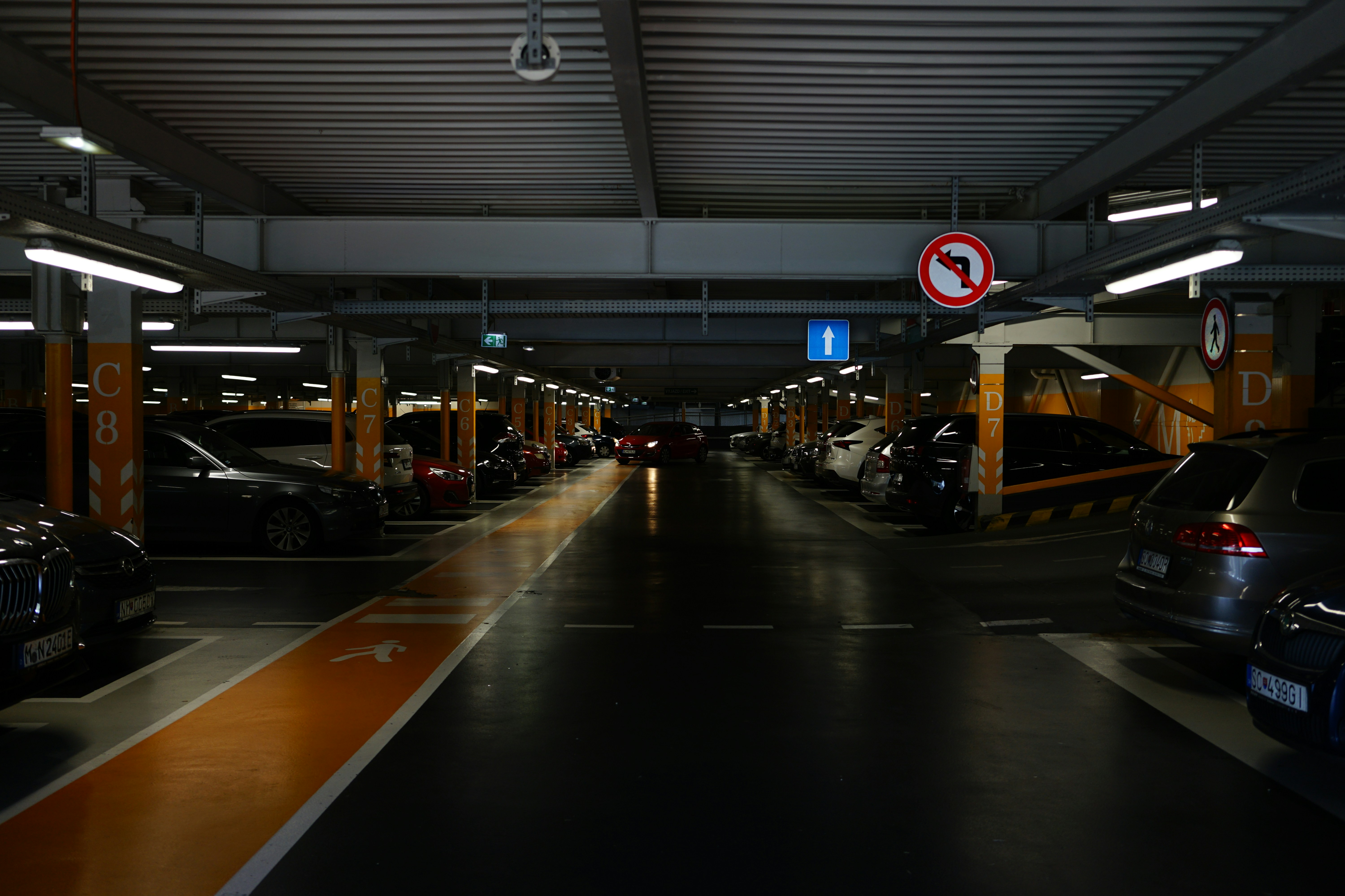 a parking garage filled with lots of parked cars