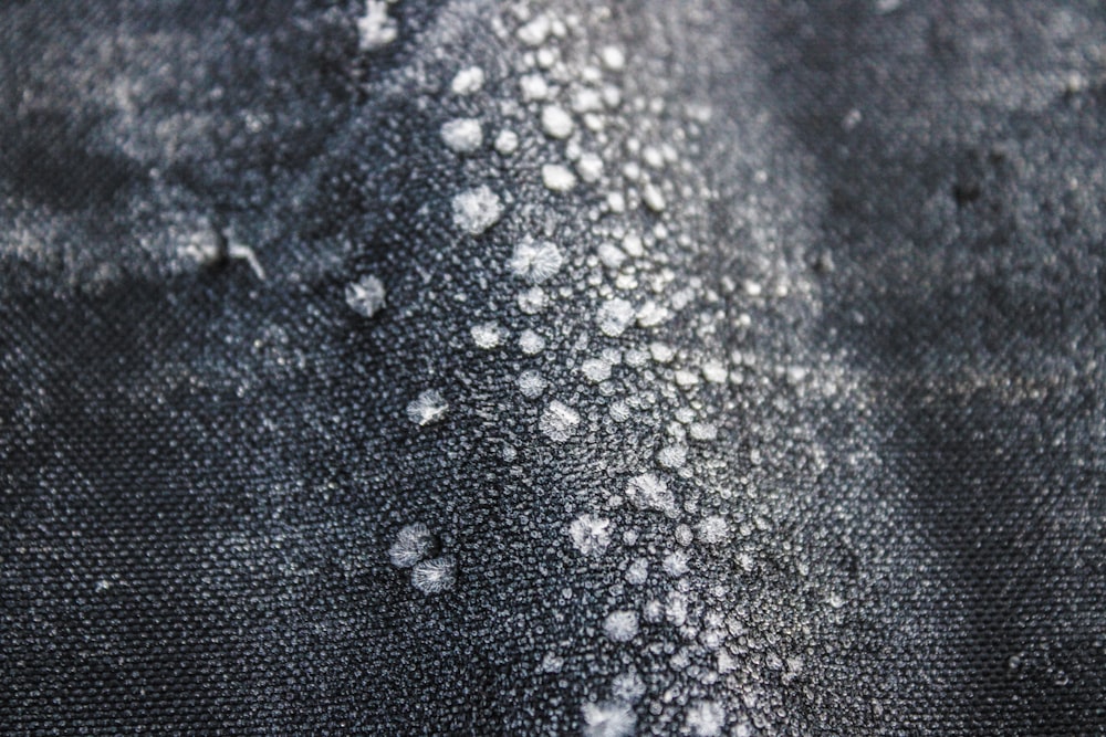 a close up of a black and white cloth with white dots on it