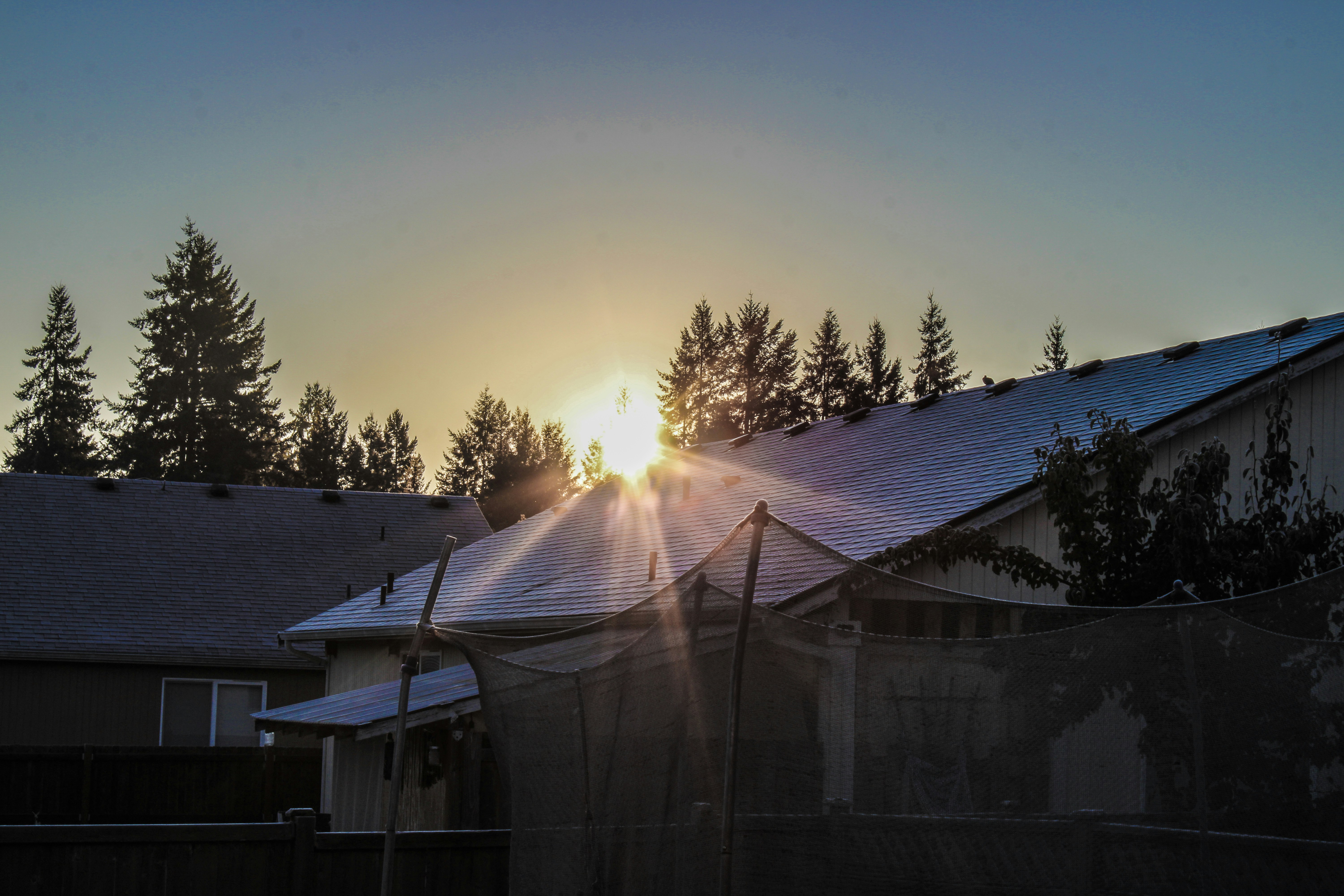 finished winter roof installation at sunset - installing asphalt shingles in winter