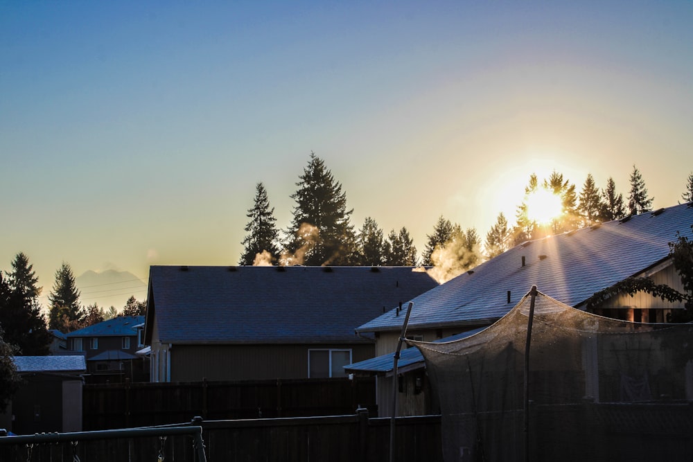 the sun is setting over a residential area