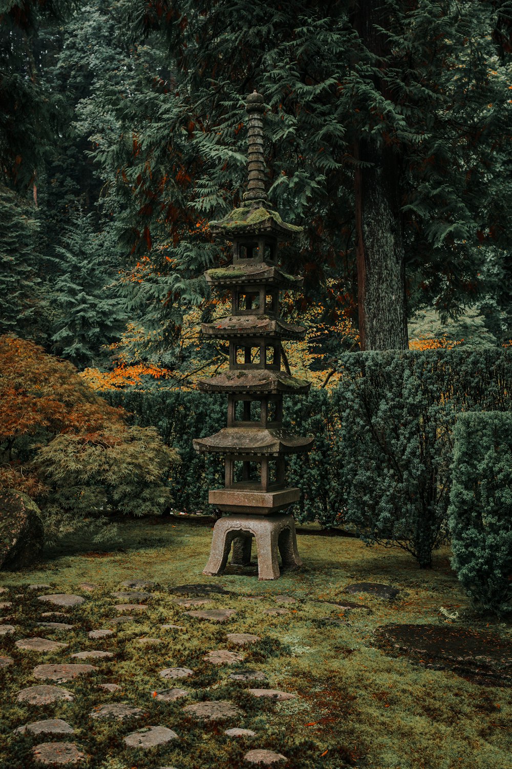 a stone pagoda in the middle of a garden