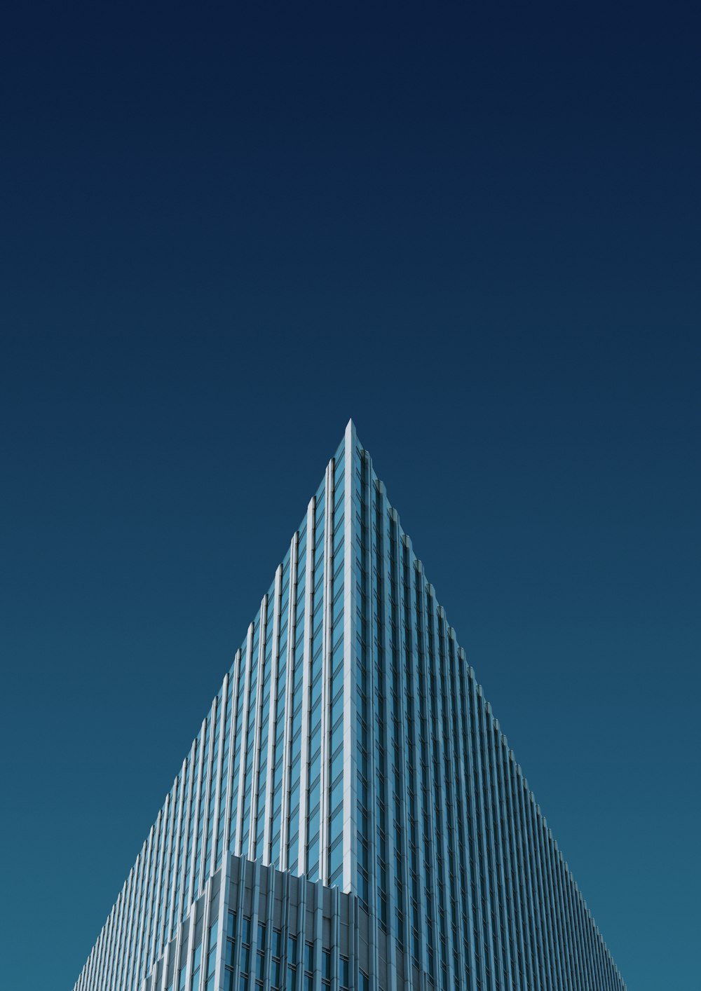a very tall building with a blue sky in the background