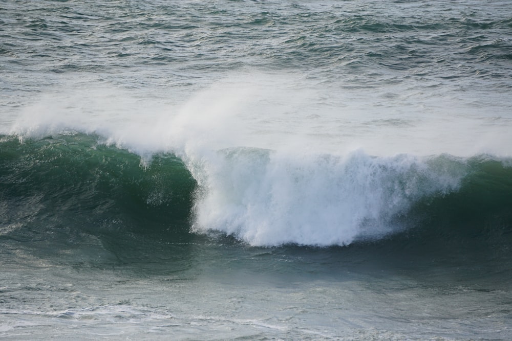 a person riding a wave on top of a surfboard