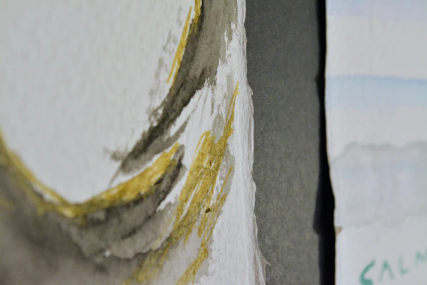 Close-up of delicate brush strokes on textured watercolor paper