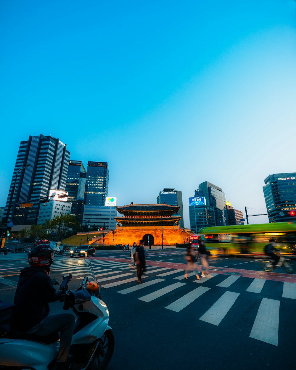 a group of people riding scooters down a street