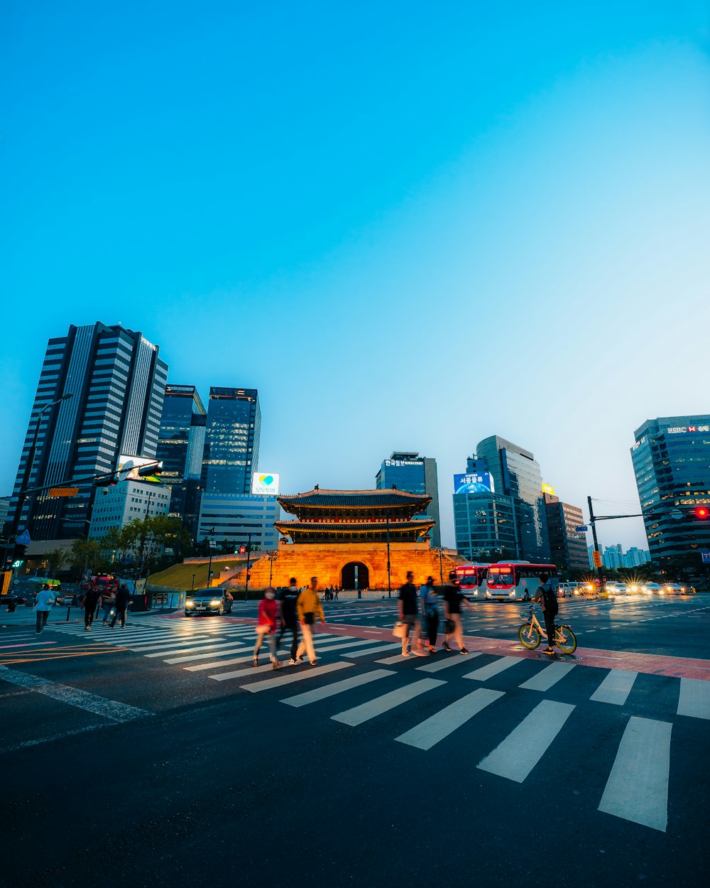 a group of people walking across a street